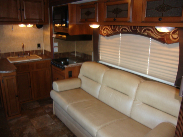 The Coachmen 320BH Class C Bunkhouse features a sofa, providing a cozy seating area for relaxing or entertaining
