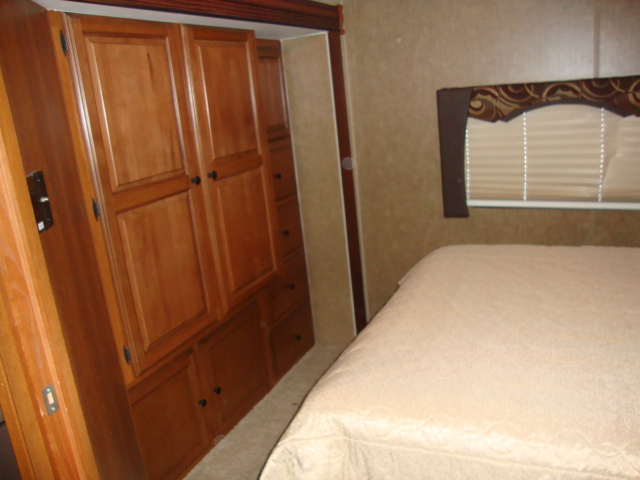 The Coachmen 320BH Class C Bunkhouse offers a comfortable bed setup, ensuring a restful night's sleep for travelers