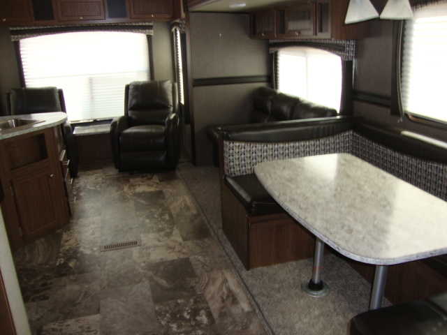 The Pioneer RL250 travel trailer boasts a spacious and modern interior design, featuring comfortable seating, ample storage, and high-quality finishes