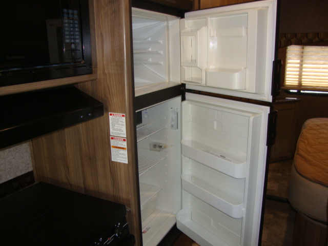 The Coachmen Freelander 21-RS features an open fridge, adding to the convenience and functionality of the kitchen area